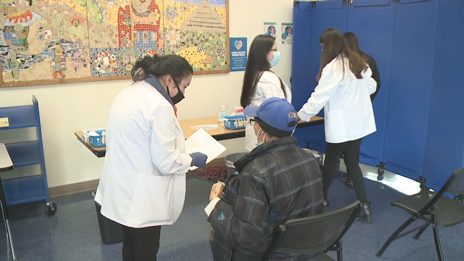 Nurses talk to vaccine clinic participants